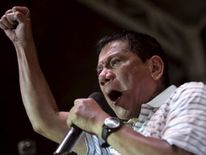 Philippine presidential candidate and Davao city mayor Duterte raises his fist while delivering statement during a campaign rally in Novaliches Quezon city, metro Manila