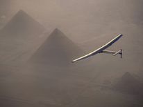 Solar Impulse 2 seen during the flyover of the pyramids of Giza on July 13, 2016 prior to the landing in Cairo, Egypt