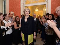 Staff clap as new Prime Minister Theresa May walks into 10 Downing Street