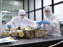 The team puts the finishing touches to the spacecraft Pic: NASA