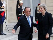 French President Francois Hollande (L) greets Britain&#39;s Prime Minister Theresa May at the Elysee Palace in Paris, France