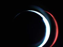 Mars can be seen as a thin white crescent in this February 2007 image from Rosetta