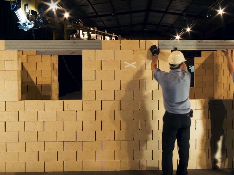 Human workers can put the finishing touches to the building