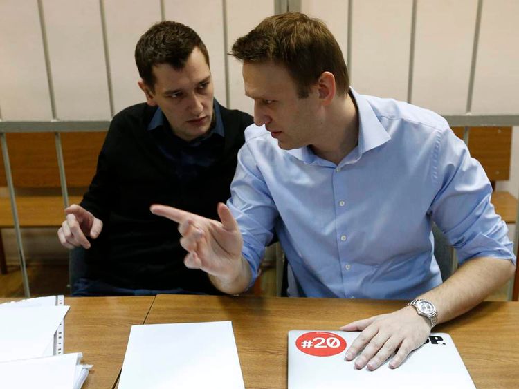 Russian opposition leader and anti-corruption blogger Alexei Navalny talks to his brother and co-defendant Oleg before a court hearing in Moscow