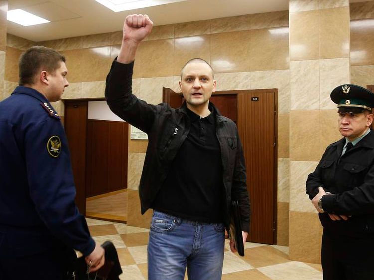 Opposition leader Udaltsov gestures as he arrives at court to attend a hearing in Moscow
