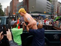 New York City Parks workers place a naked statue of U.S. Republican presidential nominee Donald Trump that was left in Union Square Park onto a truck 