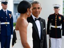 President Obama and his First Lady Michelle await the arrival of  Singapore's Prime Minister Lee Hsien Loong at the North Portico of the White House