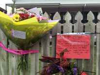 Flowers left at the backpacker hostel where the killing took place
