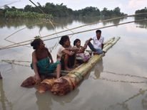 People on a makeshift raft in Morigoan district