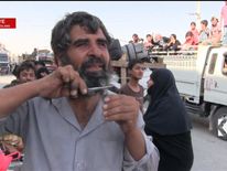 Manbij resident cuts his beard after the city is liberated from Islamic State