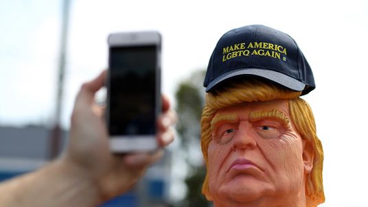 A passerby takes a picture of a statue depicting republican presidential nominee Donald Trump in the nude in San Francisco