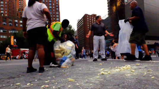 Park workers clean up the place where a statue of a naked Republican presidential candidate Donald Trump had appeared in Union Square Park, New York City