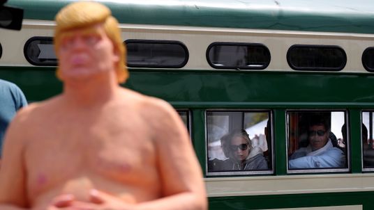Train passengers look at a statue depicting republican presidential nominee Donald Trump in San Francisco
