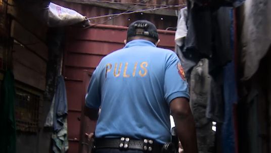 Police on a so-called &#34;knock and ask&#34; operation in Manila 