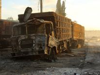 Damaged aid trucks after an airstrike on the rebel held Urm al-Kubra town, western Aleppo city, Syria