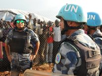 UN peacekeepers stand guard at a demonstration by people displaced by fighting near South Sudan's capital Juba