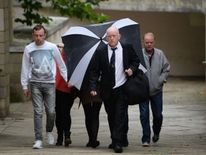 Claire Riley, 23, (behind umbrella) arrives at Northampton Crown Court to be sentenced