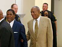 Bill Cosby is helped into the court in July when his lawyers failed to get the case against him thrown out