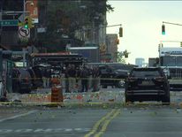 Debris and evidence litters the street as the sun rises over Manhattan