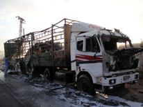 A damaged truck carrying aid is seen on the side of the road in the town of Orum al-Kubra on the western outskirts of the northern Syrian city of Aleppo