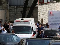 An ambulance transports the body of Nahed Hattar to hospital
