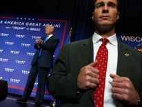 A Secret Service agent watches from the edge of the stage as Republican presidential nominee Donald Trump holds a campaign rally in Green Bay, Wisconsin, U.S. October 17, 2016. REUTERS/Jonathan Ernst