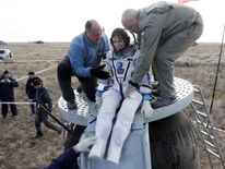 US astronaut Kate Rubins is helped out of the craft