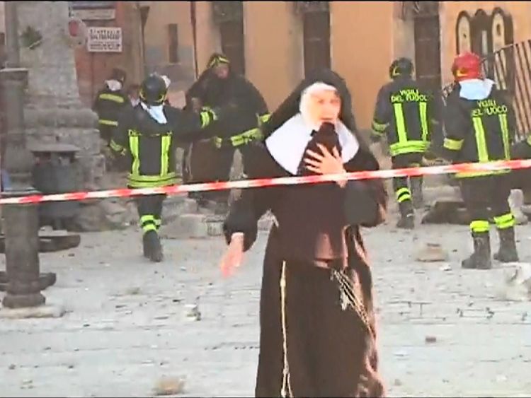 Rescue workers help as nuns flee from damaged buildings in Norcia