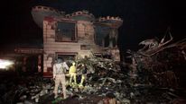 Iraqi security forces inspect the site of the blast