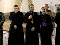 Priests at the Mart Shoomy Church in Bahzani survey to destruction carried out by IS