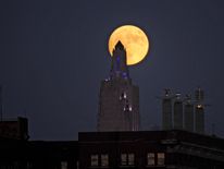 The "supermoon", the closest the moon comes to Earth since 1948, rises over the Power and Light building in downtown Kansas City, Missouri, U.S., November 13, 2016