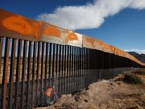 A U.S. worker inspects a section of the U.S.-Mexico border wall at Sunland Park, US