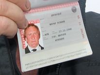 A close up of French actor Gerard Depardieu, who has threatened to quit his homeland to avoid higher taxes, showing off his new Russian passport on January 6, 2013 at Mordovia airport in Saransk where he has been offered residence in this central Russia region known for Stalin-era Gulag labour camps. The former Oscar nominee travelled to snow-covered Mordovia a day after he met with strongman President Vladimir Putin at his sumptuous Black Sea villa in the resort town of Sochi for friendly bante