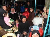 Syrian families are evacuated through Sheikh Maqsud, a Kurdish-controlled enclave between east and west Aleppo