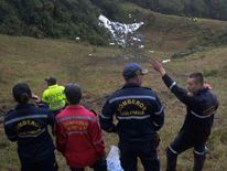 Rescuers near the wreckage of the LAMIA airlines charter plane 