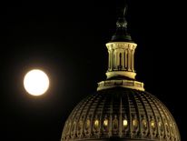 The supermoon rises over the United States Capitol dome in Washington, U.S., November 13, 2016