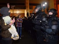 A protester gestures at police at Pioneer Square in Portland, Oregon 