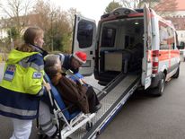 An elderly resident is evacuated from Augsberg by paramedics
