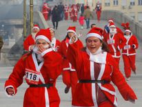 Runners dressed as Santa Claus take part in the annual Christmas race on the streets of Skopje, Macedonia