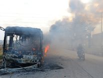 A bus burning as it made its way to evacuate people from besieged cities
