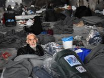 Syrians who fled from rebel-held areas in east Aleppo gather on December 1, 2016 at a warehouse turned into shelter in Duweirineh, a small village on the eastern outskirts of the embattled city. More than 50,000 Syrians have joined a growing exodus of terrified civilians from the besieged rebel-held east of Aleppo, the Syrian Observatory for Human Rights monitor said, as the UN Security Council was set for emergency talks on fighting in the city. / AFP / George OURFALIAN (Photo credit should rea