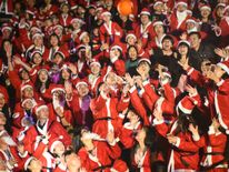 People don Santa costumes for a game in Shenzhen, Guangdong Province, China
