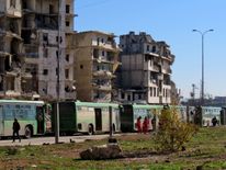 People gather to be evacuated from a rebel-held sector of eastern Aleppo