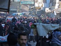 People gather to be evacuated from a rebel-held sector of eastern Aleppo
