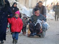 People gather to be evacuated from a rebel-held sector of eastern Aleppo