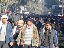 People gather to be evacuated from a rebel-held sector of eastern Aleppo