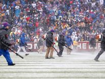 Stadium workers in Orchard Park, NY, trying to clear the field of snow Credit: Kevin Hoffman-USA TODAY Sports