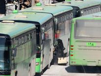 People gather to be evacuated from a rebel-held sector of eastern Aleppo