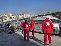 People gather to be evacuated from a rebel-held sector of eastern Aleppo