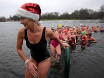 Swimmers take part in the annual Christmas Day race in the Serpentine lake in Hyde Park, London